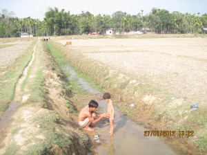 Villagers taking bath in the cannel, the only source of water.